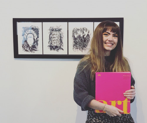 Female student holding a pink book that says art on it infront of 4 pictures